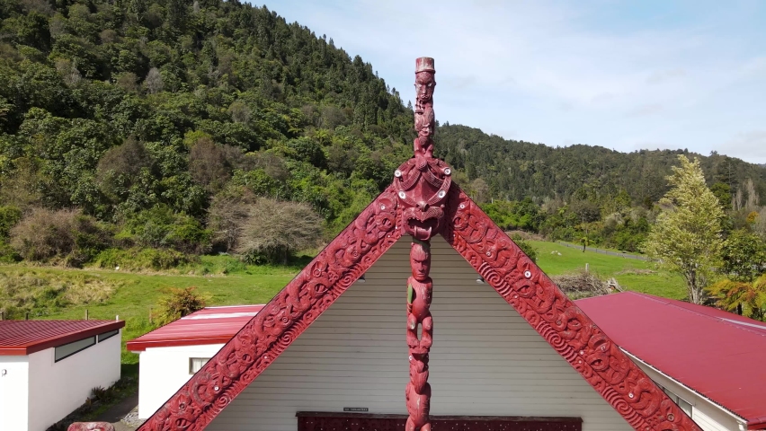 Maori carved traditional art on Marae, meeting room on Rotoiti lake. New Zealand - aerial drone | Shutterstock HD Video #1094975799