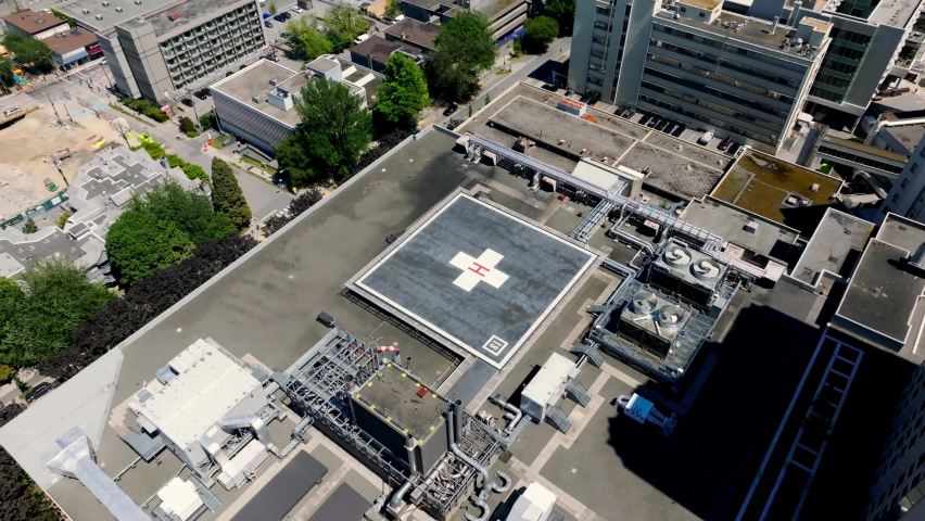Aerial View Of Helipad On Rooftop Of Vancouver General Hospital In BC, Canada. - pullback, tiltup Royalty-Free Stock Footage #1094975877