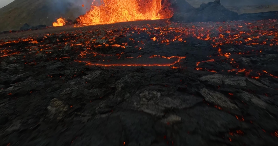 Lava outburst hitting a FPV drone while flying through a erupting Volcano scene - slow motion