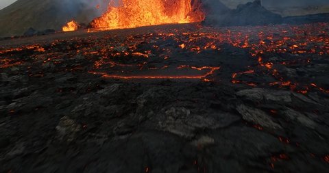 Lava outburst hitting a FPV drone while flying through a erupting Volcano scene - slow motion Stock Video