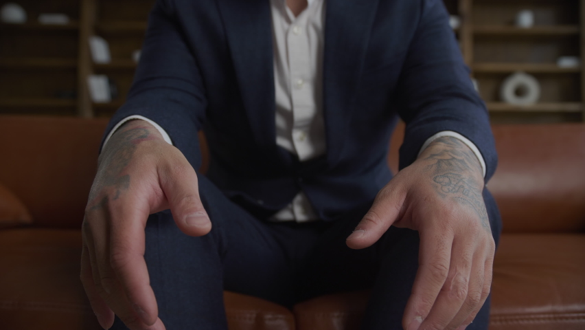 Extreme close up of businessman arms covered in tattoo wearing a suit in slow motion | Shutterstock HD Video #1094980661