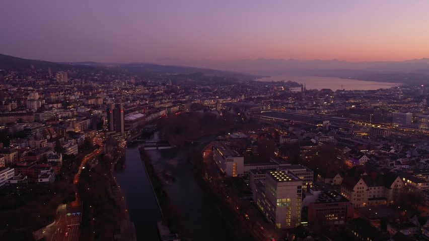 Zurich, Switzerland: Aerial drone footage of the sunset over Zurich city center with the Limmat river that flows through the old town to join lake Zurich in Switzerland. Shot as a time lapse
