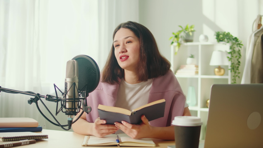 Young woman recording podcast, reading book. Podcaster, Korean female student making audio book, using microphone and laptop, broadcasting studio. | Shutterstock HD Video #1094982973