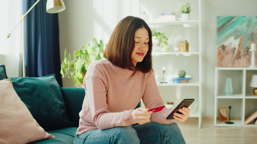 Asian woman using credit card and smartphone, shopping in app. Young Korean female student buying clothes in application, online order, food delivery.  | Shutterstock HD Video #1094983069