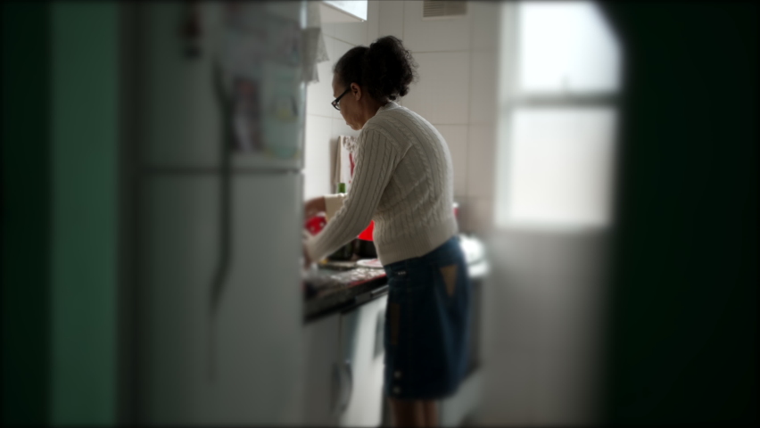 Candid Brazilian senior woman at kitchen doing housework. Authentic retired hispanic older person at home Royalty-Free Stock Footage #1094987613