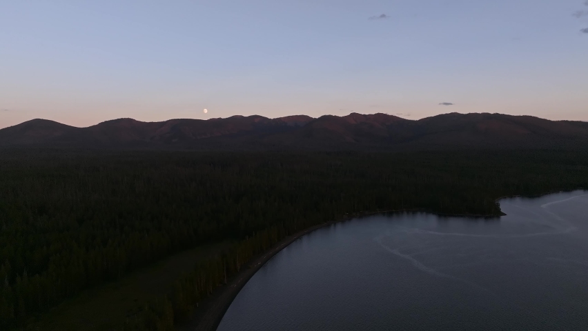 An aerial panoramic view of Yellowstone Lake from above at sunset. Beautiful huge lake inside an ancient crater. 