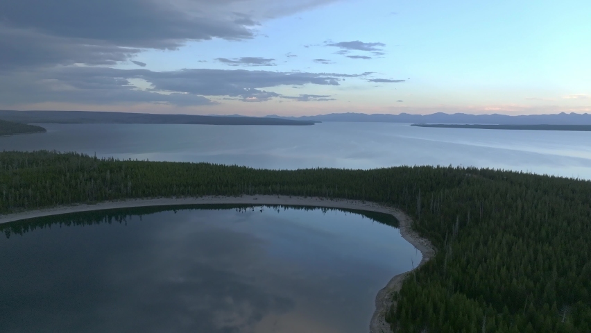 An aerial panoramic view of Yellowstone Lake from above at sunset. Beautiful huge lake inside an ancient crater. 