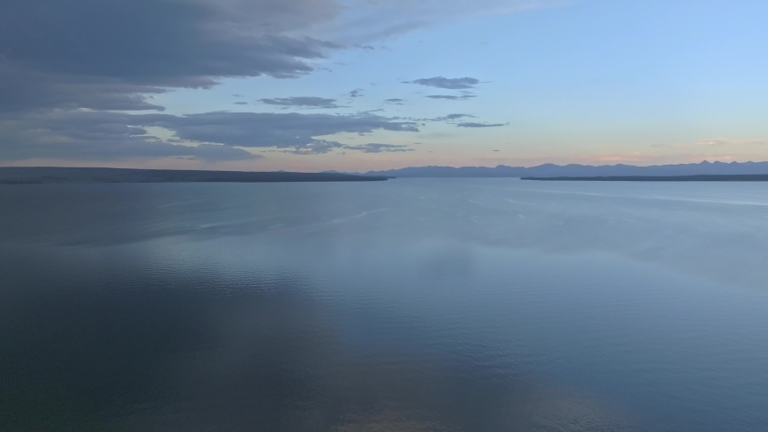 An aerial panoramic view of Yellowstone Lake from above at sunset. Beautiful huge lake inside an ancient crater. 
