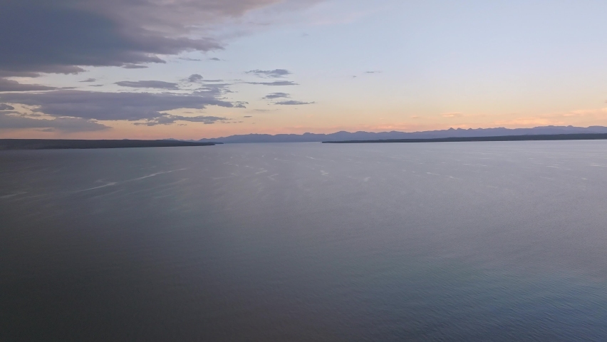 An aerial panoramic view of Yellowstone Lake from above at sunset. Beautiful huge lake inside an ancient crater. 