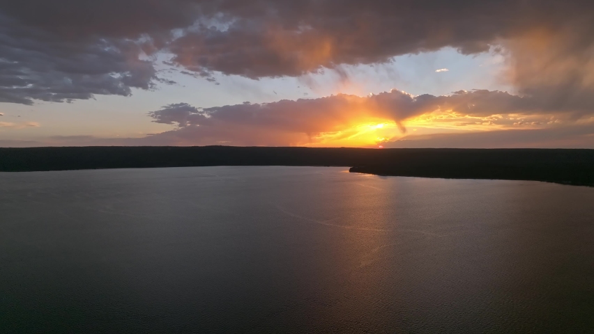 An aerial panoramic view of Yellowstone Lake from above at sunset. Beautiful huge lake inside an ancient crater. 