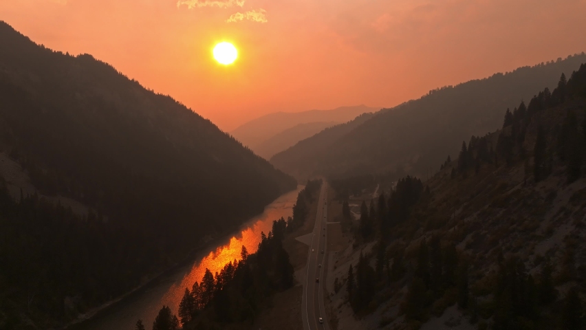 Magical aerial videos of the Highway road to sunset near Yellowstone National park. Beautiful sunset over river in Wyoming. 