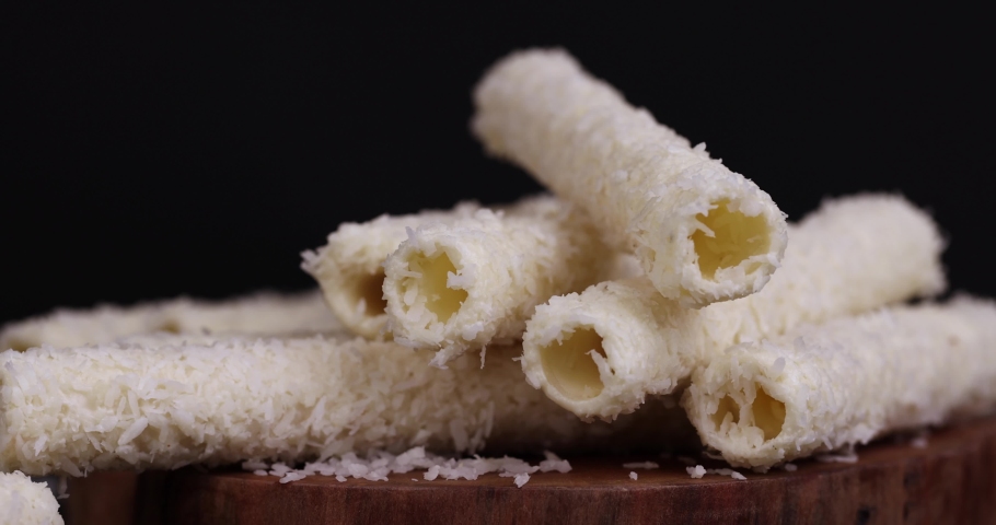 Waffle tubes with butter cream and coconut sprinkles, sweet waffle tubes with filling | Shutterstock HD Video #1094990943