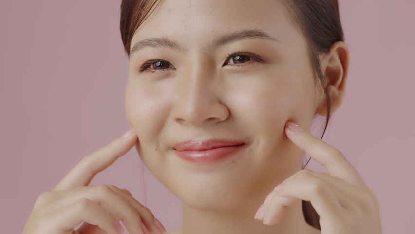 Slow motion close up perfect beauty face of young beautiful Asian woman massages her face gently with fingertips. Face cream commercial advertising concept. | Shutterstock HD Video #1094991101