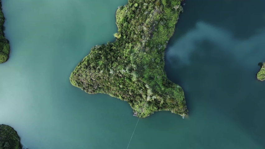 Green and Blue Turquoise Island and Divine Water Lake Aerial Drone Flying Above Guatape Landscape in Medellin Colombia