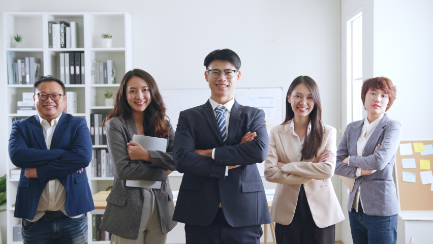 Portrait of smiling group Asian professional confident business people team standing and looking at camera Royalty-Free Stock Footage #1094992673