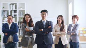 Portrait of smiling group Asian professional confident business people team standing and looking at camera - Powered by Shutterstock - Get 15% off with code: PIKWIZARD15