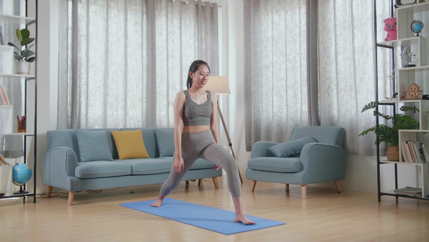 Young Asian Athletic Female Exercising, Stretching And Practising Yoga At Home. Healthy Lifestyle, Fitness, Wellbeing And Mindfulness Concept
 | Shutterstock HD Video #1094995949