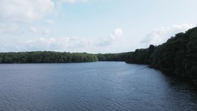 Trémelin or Tremelin lake and surrounding forest, Brittany in France. Aerial drone forward and tilt down