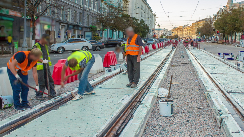 Tram rails in concrete plates on the road timelapse. Filling by liquid resin for reduction of vibration and noice. The process of reconstruction of tram tracks