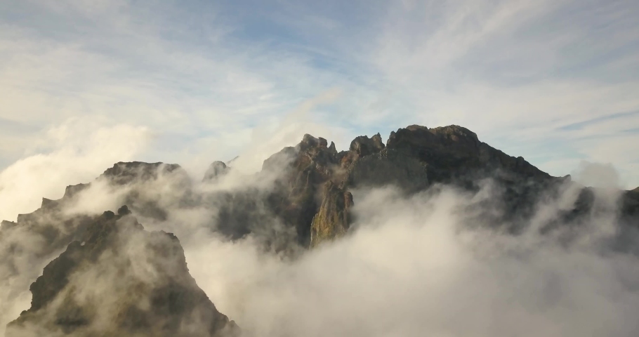 The biggest peak of Madeira island covered by clouds. Wonderful moody day on Pico do Arieiro in madeira mountains. | Shutterstock HD Video #1095003463