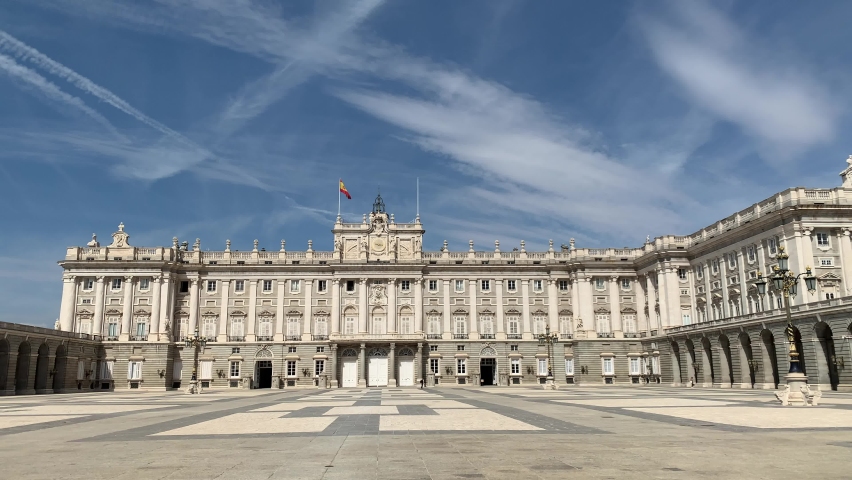 Spanish flag is waiving on top of the Royal Palace of Madrid (Palacio Real de Madrid). It is the official residence of the Spanish royal family and also is used for state ceremonies. Madrid, Spain | Shutterstock HD Video #1095003495