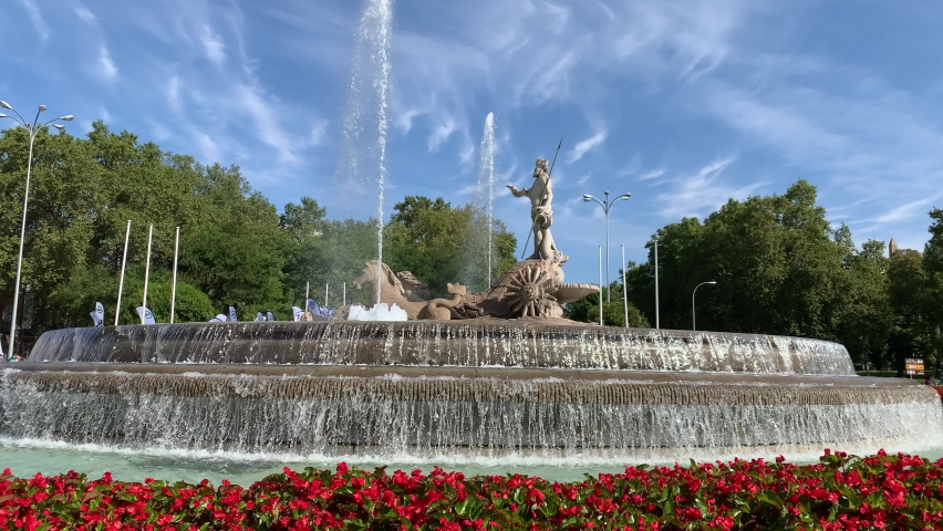 Running water and water jet sprays at Fountain of Neptune at Madrid city centre. This neoclassical fountain is in the middle of roundabout and is a very popular sightseeing place. Madrid, Spain | Shutterstock HD Video #1095003497
