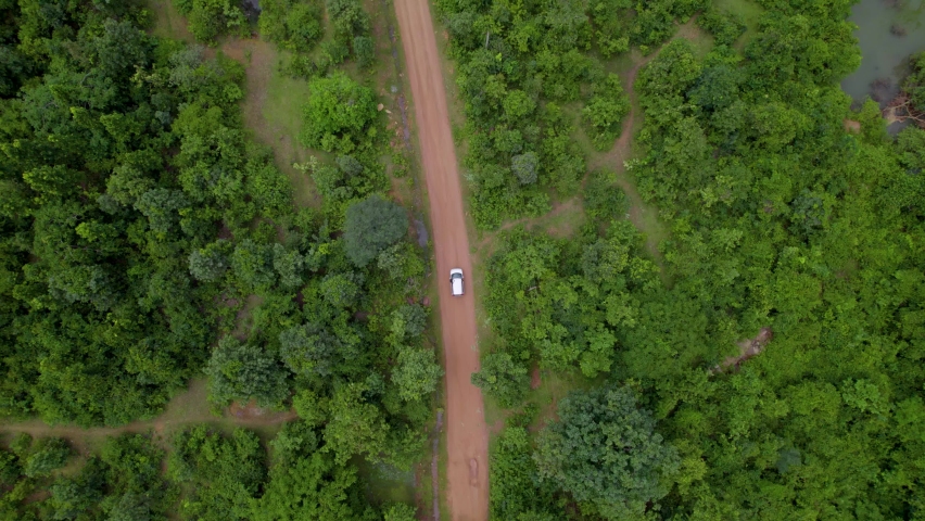Aerial view of a car in jungle, Off-roading road trip through the forest | Shutterstock HD Video #1095004443