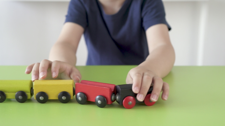 Adorable kid hand playing with wooden toy train at home | Shutterstock HD Video #1095004995