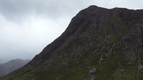 Aerial Video of the beautifully dramatic Buachaille Etive Mor on a Grey cloudy day in the Scottish Highlands - Scotlands Famous Mountain