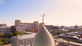 A Muslim golden dome with a crescent moon on the mosque. Minaret against the sky. Arab day. Islamic symbols of religion. Faith in Allah. Crescent moon at the top of the mosque