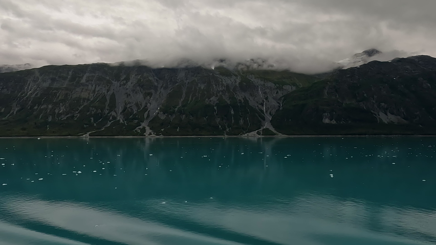 Glacier Bay cruise mountains icebergs fast. National Park and Preserve an American national park. Protected tourism destination accessible boat by sea. Ocean tidal glaciers. Environmental sensitive.