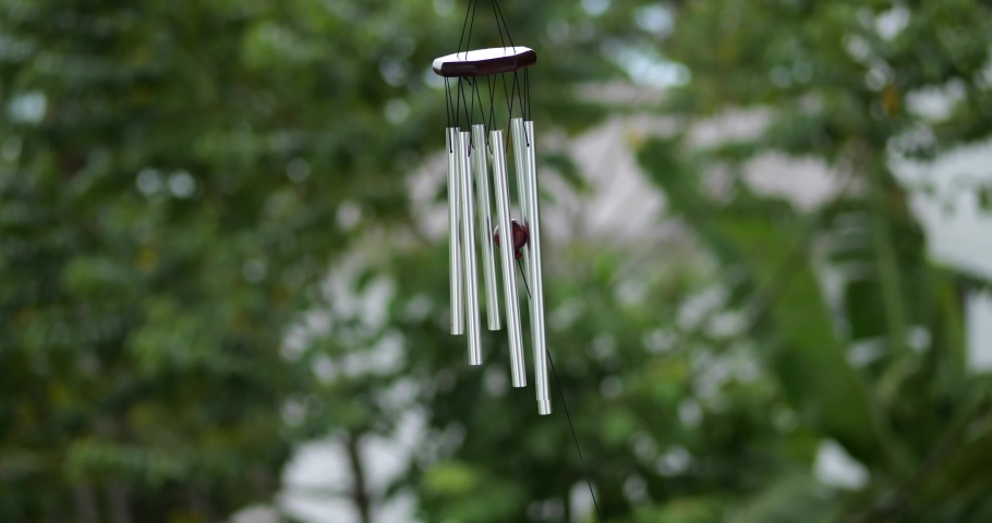 Wind Chimes hangs on the porch of the house against the backdrop of the tropical jungle and mountains Royalty-Free Stock Footage #1095016527