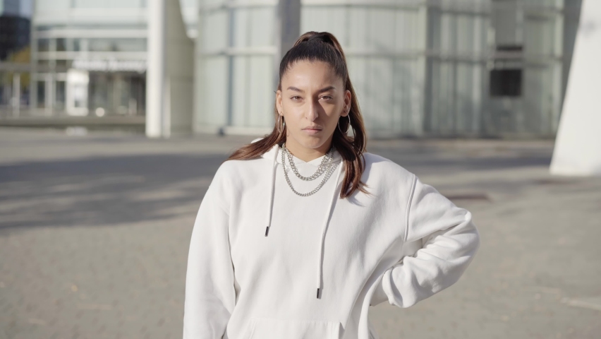 A young woman looking at the camera with a serious face. High quality photo