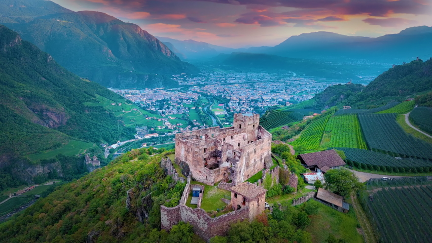 Bolzano bozen Italy city aerial drone view from sky, bolzano skyline view of old town castle city centre alps mountains at sunset colored sky. Royalty-Free Stock Footage #1095026285