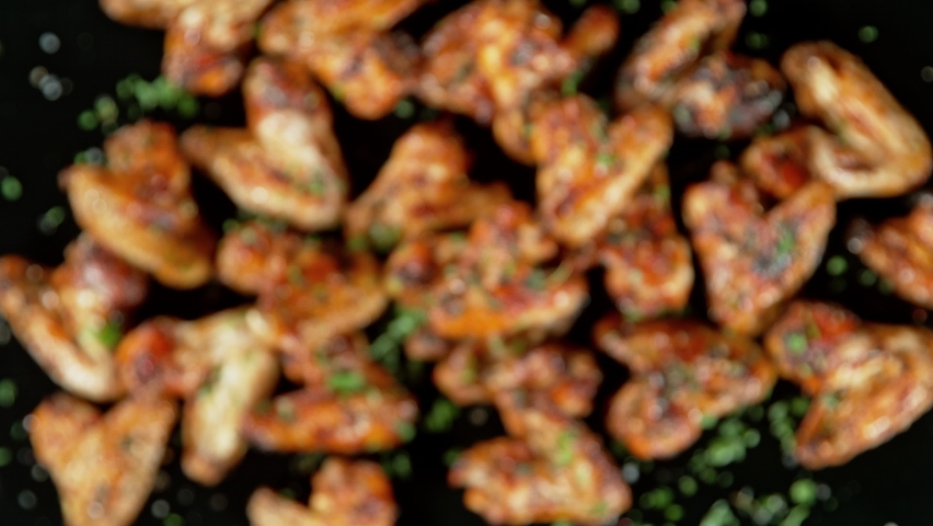 Super Slow Motion Shot of Grilled Spicy Chicken Wings Flying Towards Camera at 1000fps. Royalty-Free Stock Footage #1095029995