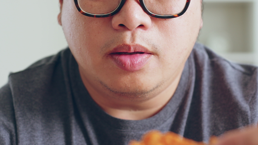 Asian fat man enjoy to eat unhealthy junk food, hamburger, pizza, fried chicken Royalty-Free Stock Footage #1095032995
