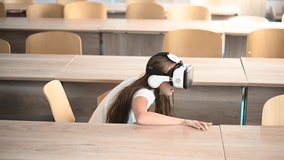 Caucasian schoolgirl wearing virtual reality glasses in the classroom.  - Powered by Shutterstock - Get 15% off with code: PIKWIZARD15