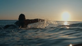 Male surfer paddles in the ocean at sunrise - Powered by Shutterstock - Get 15% off with code: PIKWIZARD15
