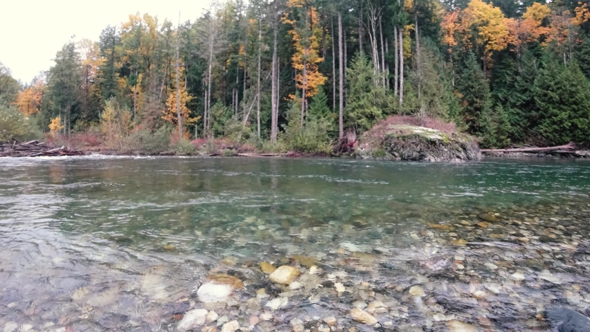 Clear water from a mountain river in autumn in Canada in the evening
