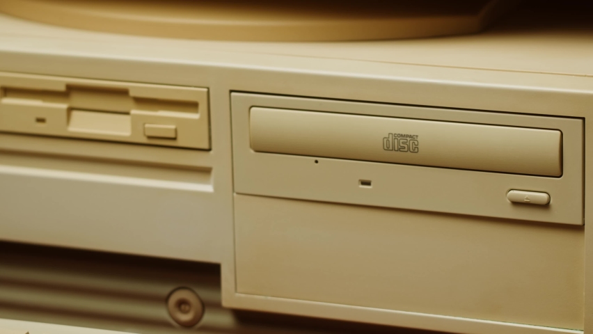 Using CD circle disk for old computer. Dvd player, disc drive. Music recorder, playing retro computer games.  Royalty-Free Stock Footage #1095040151