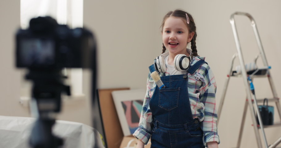 Happy child decided to record video on camera about how children