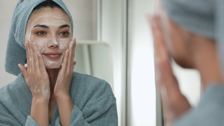 Reflection in a mirror beautiful woman washing her face | Shutterstock HD Video #1095057747