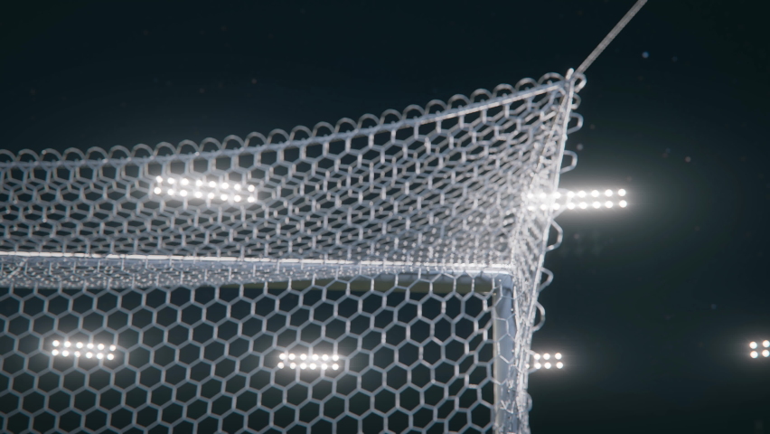 The soccer ball hits the goal net in slow motion. The goal is on the black background with bright spotlights. 3d made. | Shutterstock HD Video #1095065399
