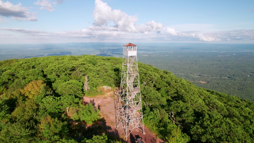 Panoramic mountaintop view of the Catskill Mountains with classic Fire Tower
