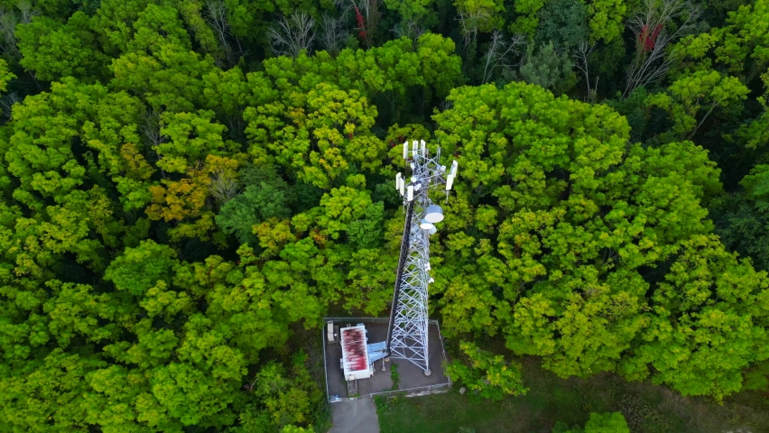Orbital aerial of a communications tower in the middle of forest trees Royalty-Free Stock Footage #1095067005