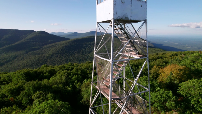Catskill Mountains Fire Tower. Late summer drone shot of mountain peaks and forests.