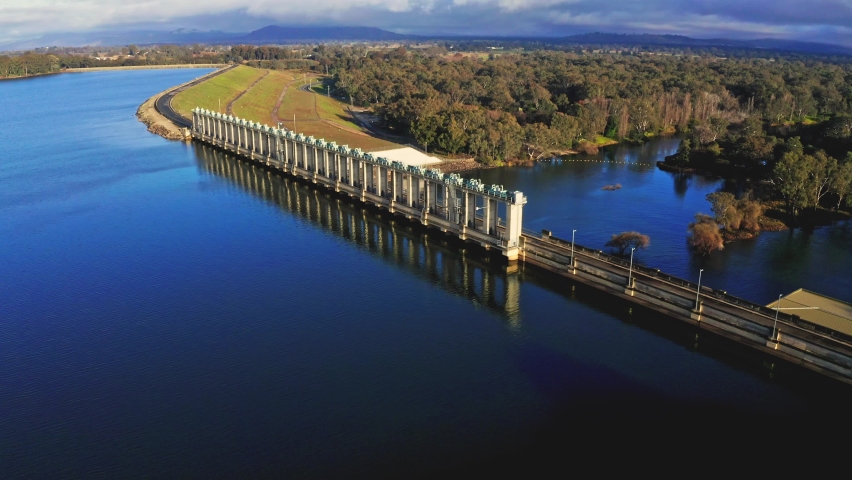 Hume Weir Dam heading West to East while rotating around wall looking down during sunrise.