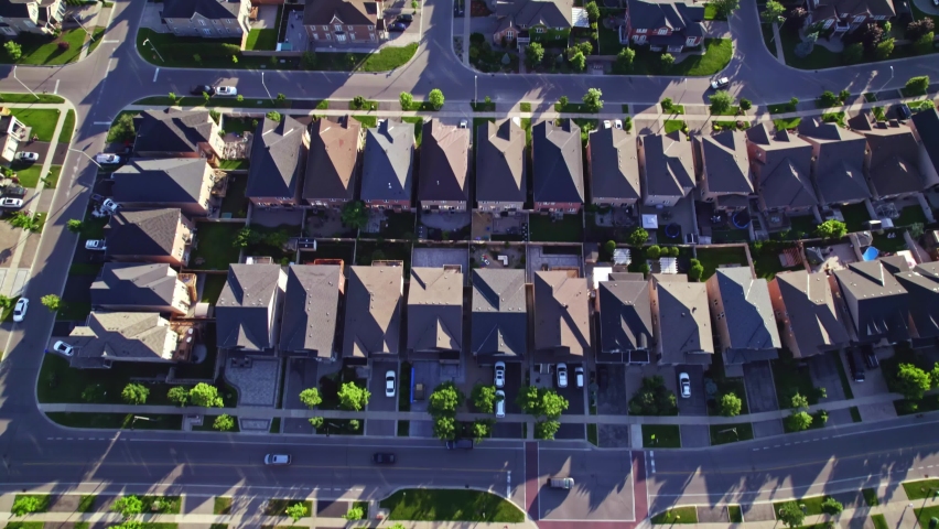 Aerial view of middle class residential houses at summer evening. American neighbourhood suburb. Residential houses and homes builder in strong pattern to each other. Real estate. Royalty-Free Stock Footage #1095072461