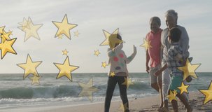 Animation of merry christmas and happy new year text with stars over biracial family at beach. Christmas, tradition and celebration concept digitally generated video.