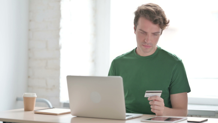 Happy Young Man Shopping Online on Laptop
